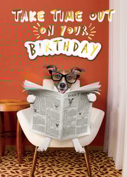 A dog wearing glasses is reading the daily dog newspaper.
