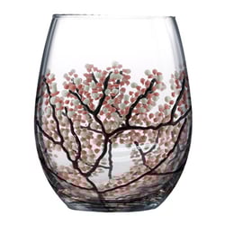 A wine glass with a tree design on it.