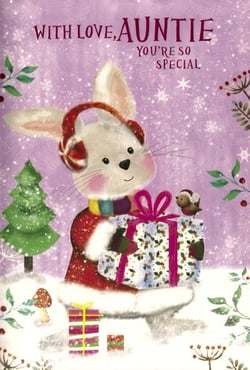 A Christmas card with a rabbit holding a gift in the snow.