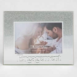 A picture frame with a picture of a man and woman and the words "engagement" on it.
