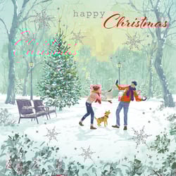 A Christmas card with a man and woman playing in the snow.