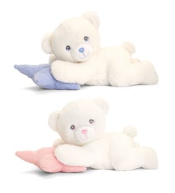 A white teddy bear is lying on a pink pillow.