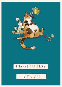A cat wearing a party hat sits on a table with cupcakes and says, "I heard you like to party."