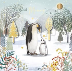 A penguin and a baby penguin are standing next to one another in a snowy forest.