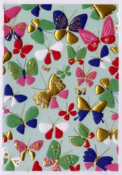 A pattern of colorful butterflies on a green background.