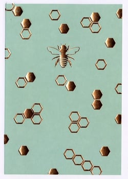 A bee is surrounded by honeycombs against a blue background.
