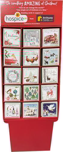 a display of hospiceux christmas cards on a stand