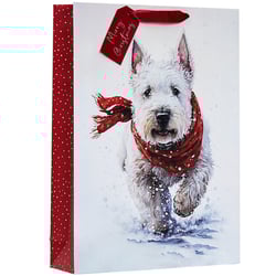 a gift bag with a picture of a dog and a tag that says merry christmas