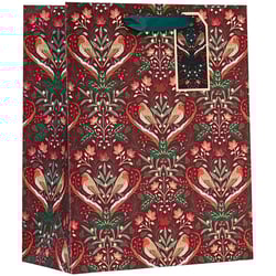 a red gift bag with birds and flowers on it
