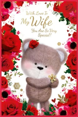 a teddy bear is surrounded by red roses and says " with love to my wife you are so very special "