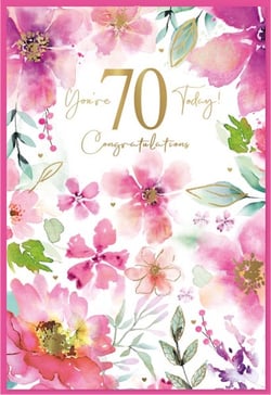 a 70th birthday card with pink flowers and green leaves