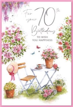 a 70th birthday card with a table and chairs and flowers .