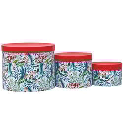 three round boxes with a floral design on them