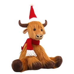 a stuffed cow wearing a santa hat and scarf