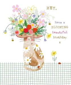Nigel Quiney Publications presents this charming 'Open Birthday Female' card, sure to brighten any recipient's day. This delightful design features a sweet watercolour cat, adorned with a magnificent hat overflowing with colourful blossoms. Bees flit among the flowers, while playful ladybirds explore the green checkered ground below. The cat itself is decorated with lovely daisy patterns, adding to its whimsical appeal. With the heartfelt message, "HEY, have a BLOOMING beautiful birthday x", this card is perfect for sending warm wishes. Stock up with our convenient pack of 6 and offer your customers a truly beautiful birthday greeting.
