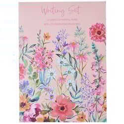 a pink writing set with flowers on it