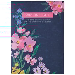 a writing set with pink flowers on a dark blue background