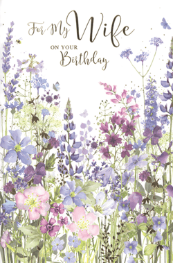 Celebrate her special day with our beautiful 'Wife' birthday card from Simon Elvin. This charming design features a stunning watercolour illustration of a vibrant wildflower meadow, bursting with delicate purples, blues, and pinks. Elegant script lettering reads 'For My Wife ON YOUR Birthday', making it a truly heartfelt choice for a loved one. The intricate details, including a busy bee and fluttering butterflies, add a touch of natural beauty. Stock up on this popular design, available in a convenient pack of 6, perfect for your customers looking for that extra special card.