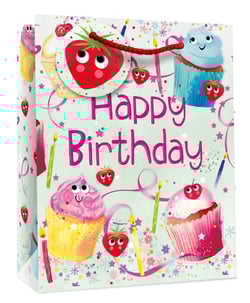 a happy birthday bag with cupcakes and strawberries on it