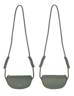 a green leather purse with a braided strap on a white background .