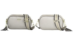 a white purse with a black and gold strap and a tassel