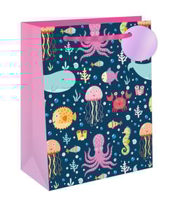 Dive into a world of aquatic wonder with our Extra Large Under The Sea Gift Bag! Perfect for birthdays, parties, or any special occasion, this vibrant bag is adorned with an adorable cast of marine characters. Cute whales, playful octopuses, charming jellyfish, and colourful fish swim across a deep blue background, surrounded by bubbles and coral. The bright pink sides and handles add a cheerful pop of colour, complemented by a lovely purple gift tag. Its generous size makes it ideal for holding all sorts of treasures. Stock up on these delightful bags, available in a convenient pack of 6, and make every gift feel like an ocean adventure!