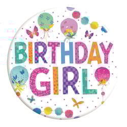 A pink birthday girl badge with stars and balloons.