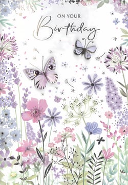 Celebrate her special day with this enchanting 'On Your Birthday' card. Adorned with a beautiful array of watercolour-style flowers in soft lavenders, pinks, and greens, it captures the serene beauty of a blossoming garden. Delicate butterflies, with a subtle shimmer, gracefully flutter amongst the blooms, adding an elegant touch. The heartfelt message, presented in a charming script, makes this card a truly lovely way to convey your warmest wishes. A delightful and pretty choice for any female recipient, ensuring her birthday feels extra special.