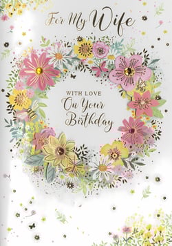 Presenting the beautiful 'Wife' birthday card from Simon Elvin, designed to make her day truly special. This exquisite card features a vibrant floral wreath, brimming with charming pink and yellow blooms, delicate daisies, and lush green foliage. Adorned with sparkling gem embellishments, intricate butterflies, and a sweet little bee, it offers a wonderful tactile experience. The elegant gold script conveys a loving message: 'For My Wife, With Love, On Your Birthday'. A truly delightful choice for any retailer, these cards are supplied in convenient packs of six, ensuring your customers can find the perfect way to express their affection.