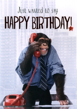 A chimpanzee, in a blue shirt and tie, talking on a red telephone with the words, just wanted to say happy birthday.