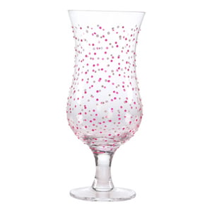 A clear glass with pink and white polka dots on it.