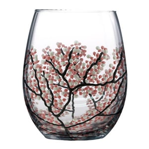 A wine glass with a tree design on it.