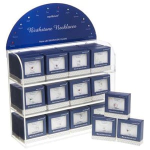 A display of birthstone necklaces made with Swarovski crystals.