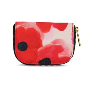 A small purse with zipper and red flowers on it.