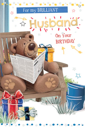 A birthday card with a teddy bear reading a newspaper for a husband.