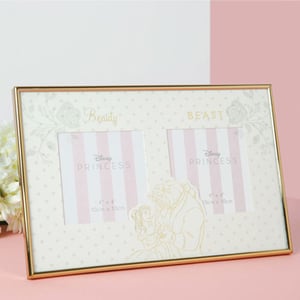 A picture frame that says "Beauty and the Beast" on it.