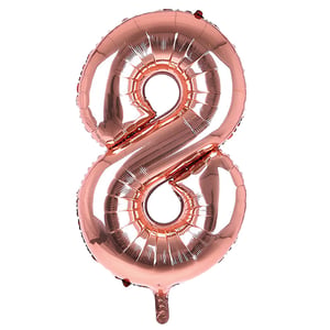 A rose gold balloon in shape of the number eight.