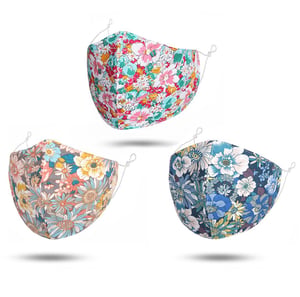 Three face masks with different floral designs on them.