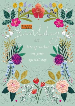 it is a birthday card with flowers and leaves on it .
