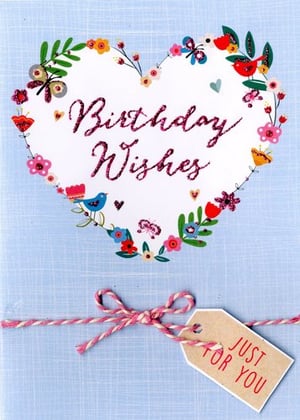 A birthday card with a heart surrounded by flowers and a tag that says "just for you."