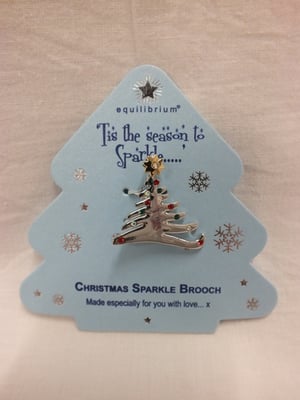 A Christmas sparkle brooch in the shape of a Christmas tree.