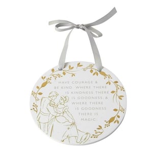 A white plaque with a quote from Cinderella on it.