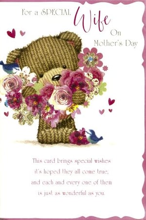 A mother's day card with a teddy bear holding flowers.