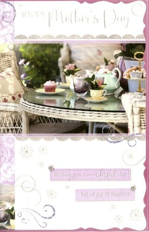 A mother’s day card with a tea set is on a table.