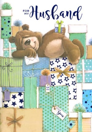 A teddy bear is lying on top of a pile of gifts.