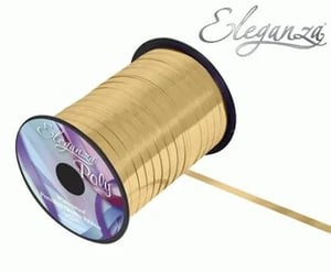 A spool of gold ribbon on a white background.