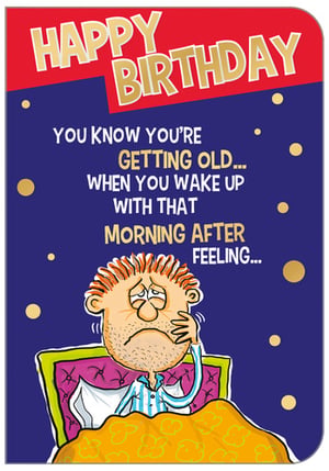 A birthday card with a cartoon of a man in bed that is happy.