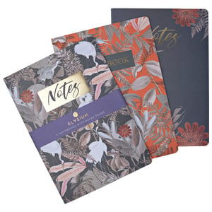 Three notebooks from Elysium are stacked on top of one another.