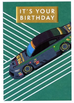 A birthday card with a race car on it that says "it's your birthday."