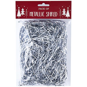 A package of metallic shred with Christmas trees on it.